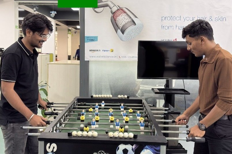 WaterScience team playing foosball in the office