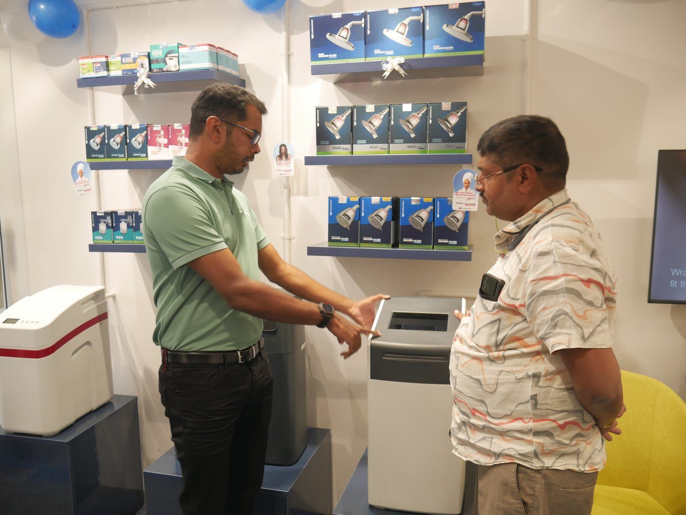 WaterScience associate demonstrating a product in an experience store