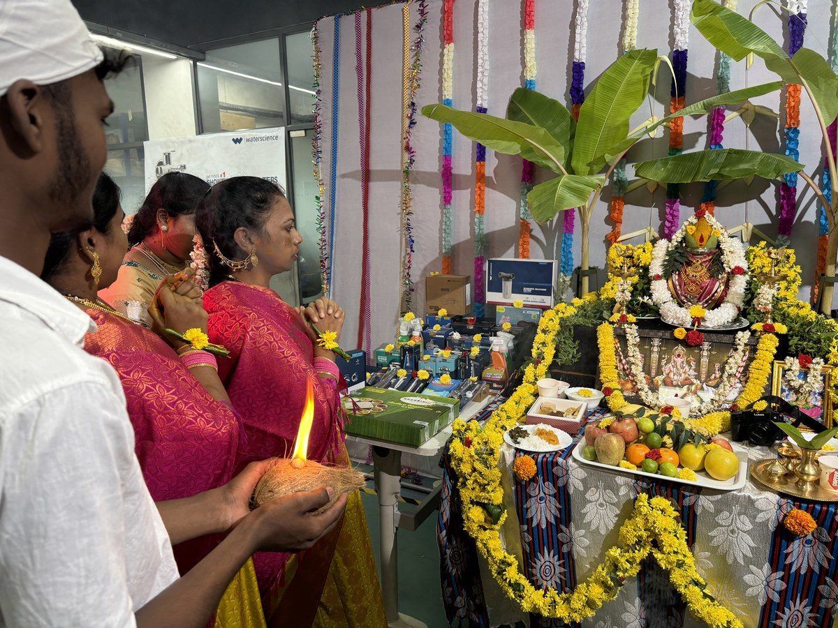 Team posing in an Onam festival photo frame