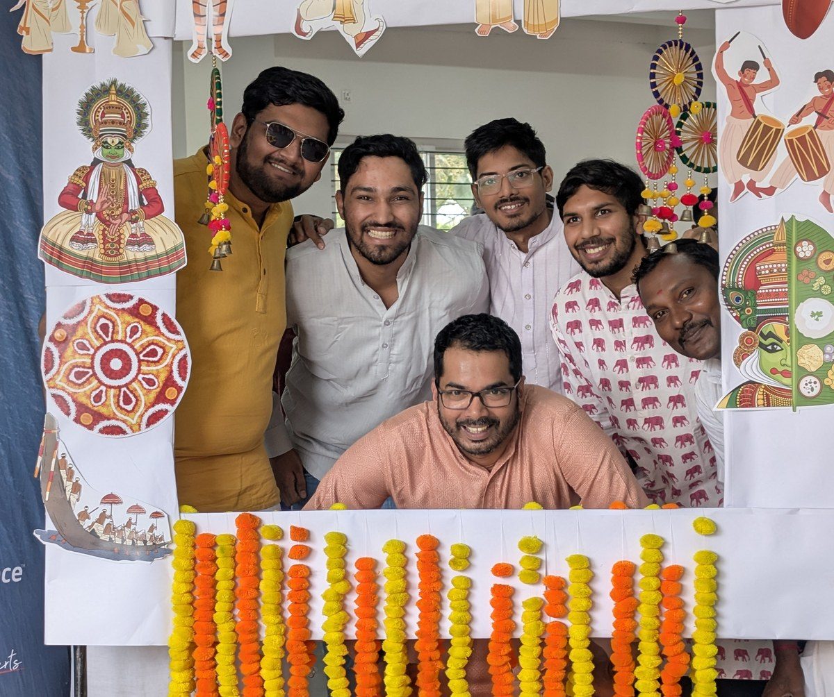 Team members performing a festive office puja